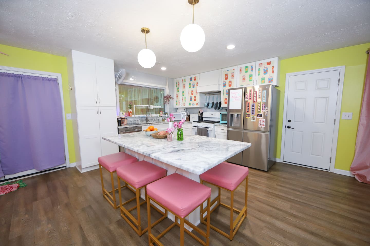 Colorful kitchen with pink bar stools